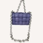 Close-up of Bottega Veneta purple leather Cassette Bag with silver chain handle