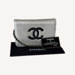 Chanel silver leather WOC with crossbody chain and snap flap closure