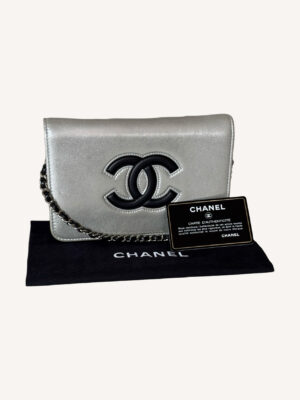 Chanel silver leather WOC with crossbody chain and snap flap closure