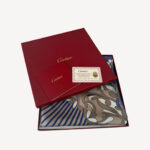 Elegant Cartier Must De Cartier scarf featuring a black panther motif with colorful floral accents, crafted from silk