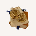 Oversized designer hoop earrings by Louis Vuitton with signature logo detail