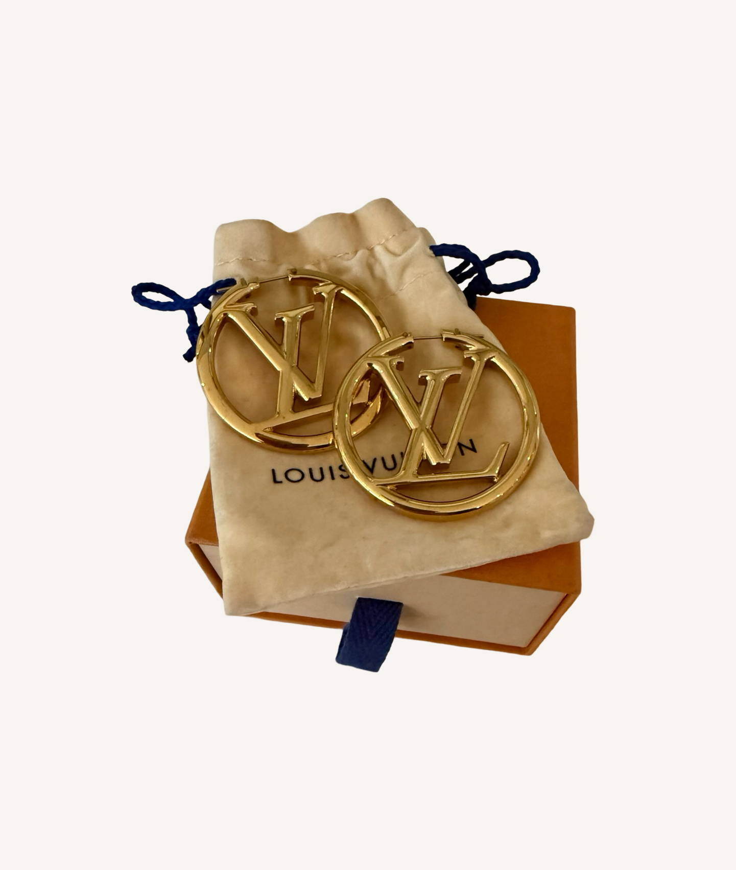 Oversized designer hoop earrings by Louis Vuitton with signature logo detail