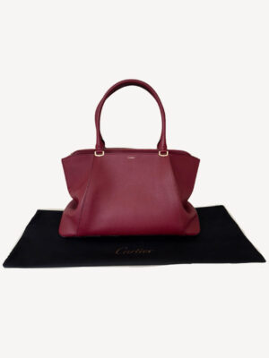 Luxury Cartier C De Cartier handbag crafted from burgundy spinel bull calfskin leather