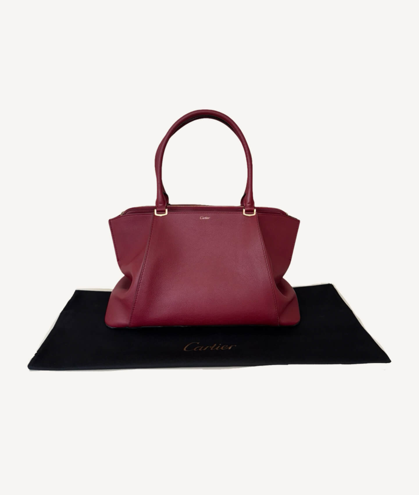 Luxury Cartier C De Cartier handbag crafted from burgundy spinel bull calfskin leather