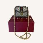 Gucci Ophidia Mini Top Handle Bag in beige and ebony GG Supreme canvas with brown leather trim and gold-toned hardware