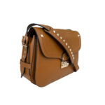 Luxury Valentino leather bag in brown with adjustable strap and flap closure