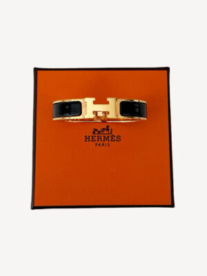 iew of Hermès Le Bracelet Clic H in noir with gold-tone and H clasp