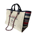 Chanel large Deauville Tote in textured canvas featuring dual straps and iconic branding detail