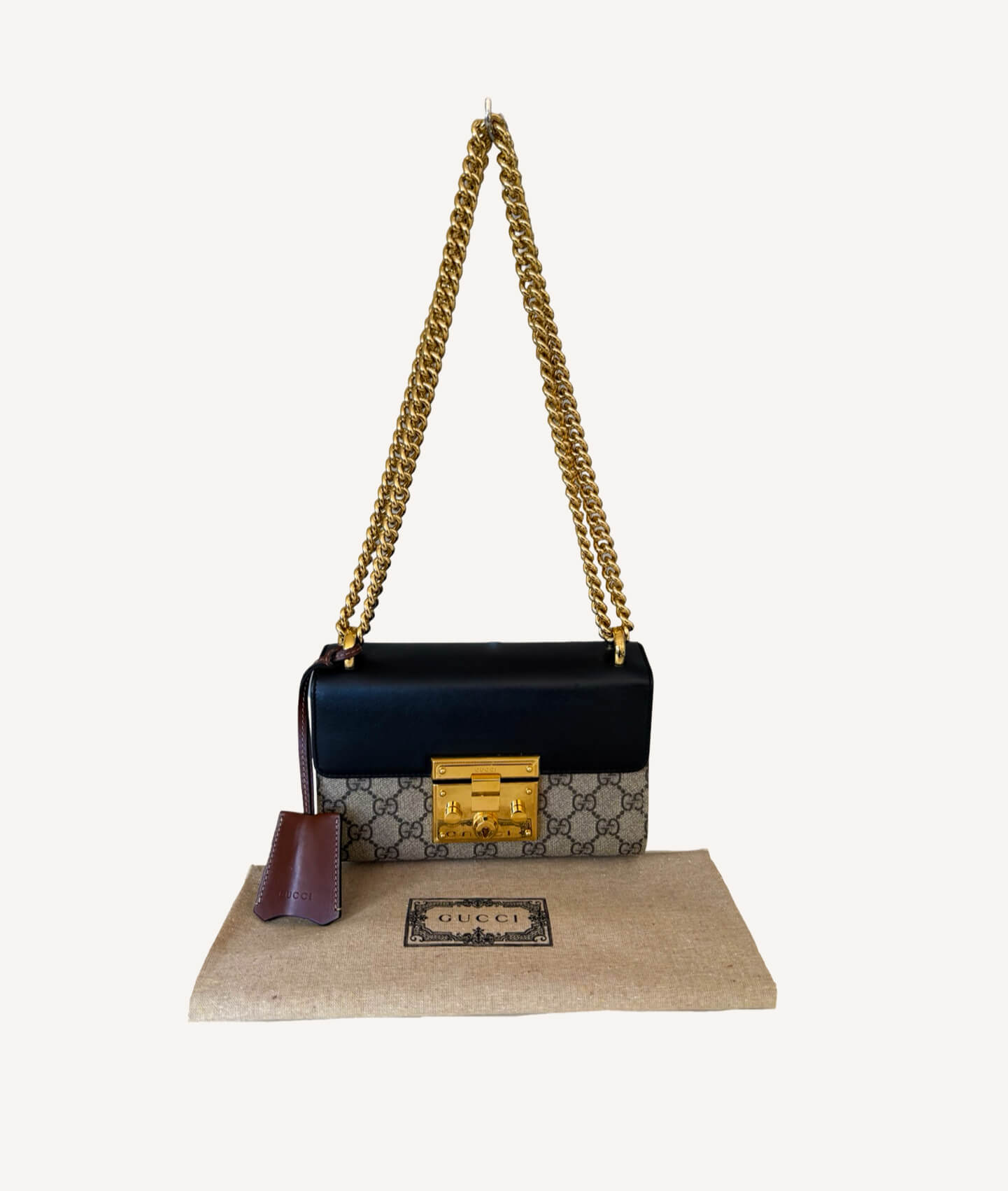 Gucci Padlock Small Shoulder Bag in beige/ebony GG Supreme canvas with black leather top, gold padlock detail and sliding chain strap