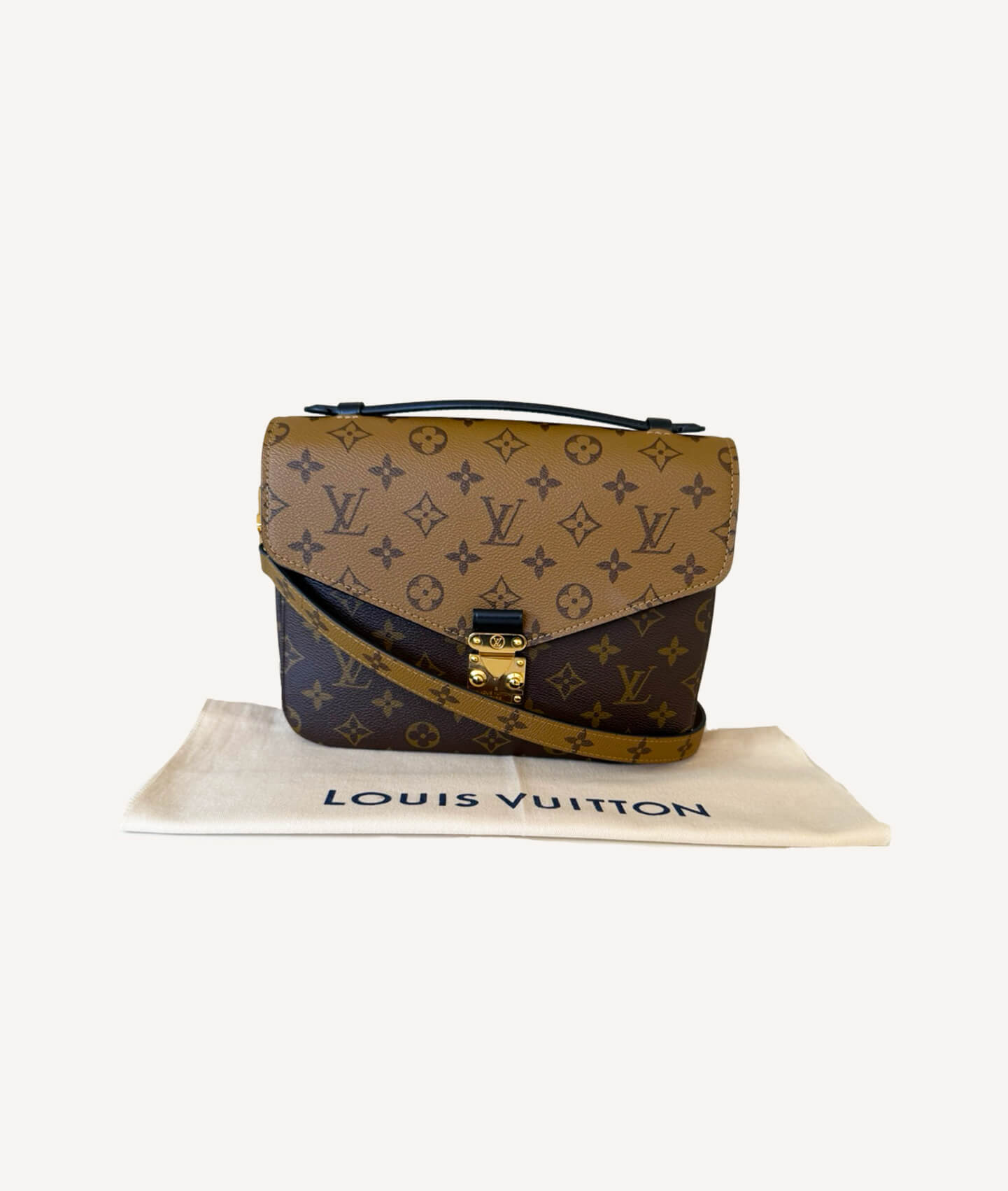Louis Vuitton Pochette Métis Reverse in monogram reverse canvas with gold S-lock and top handle.