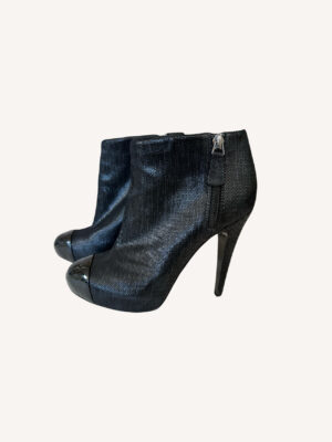 Chanel leather ankle boots with black cap toe and interlocking CC logo