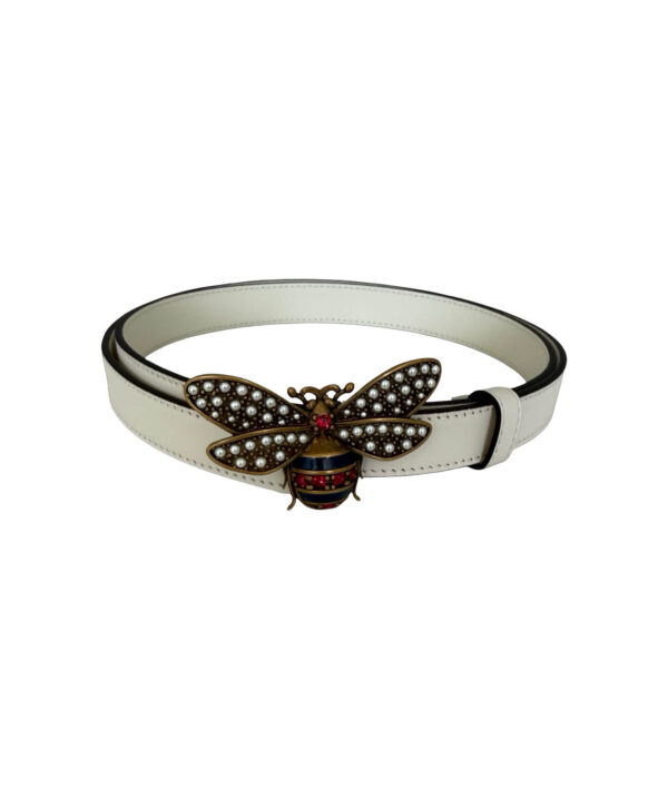 Gucci white leather belt with iconic crystal bee buckle — statement designer piece symbolizing power, femininity, and timeless style.