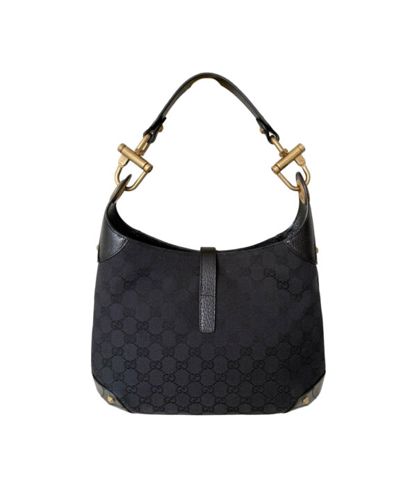 Gucci Jackie shoulder bag featuring black GG canvas and signature piston lock closure